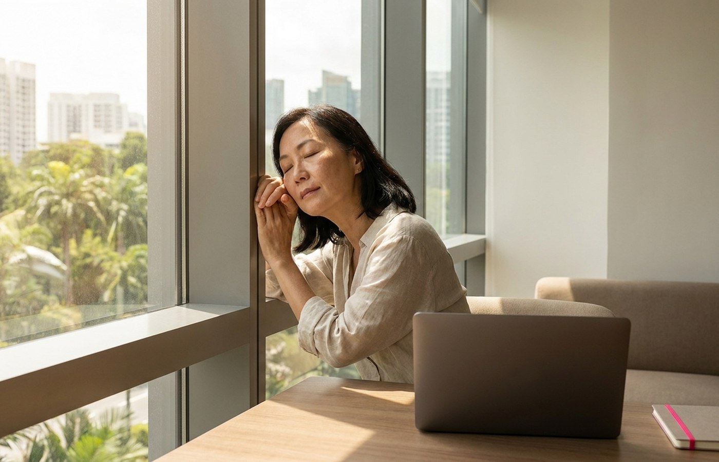 Professional taking a restorative pause beside an office window